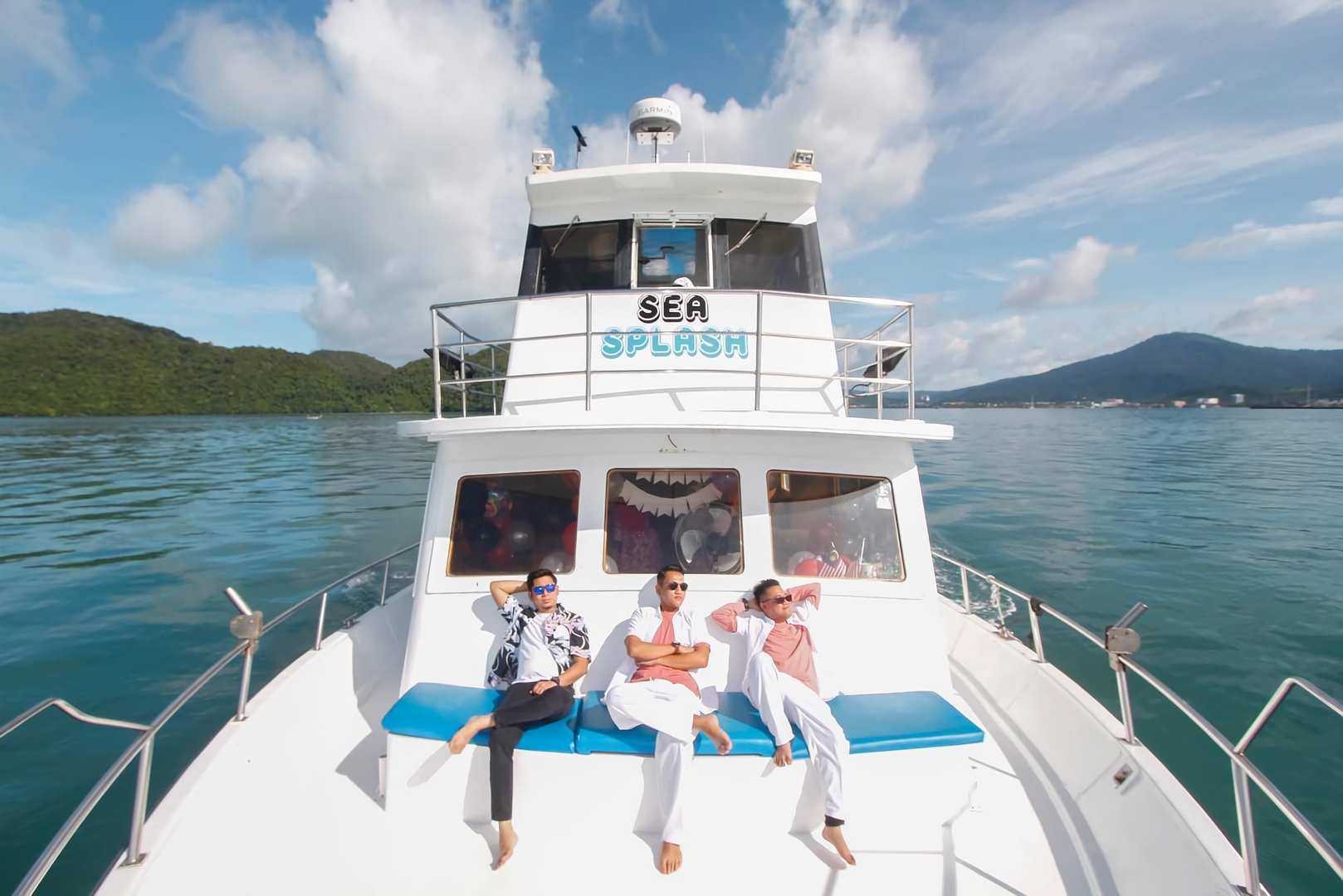 Three men relaxing on Langkawi halal sunset cruise